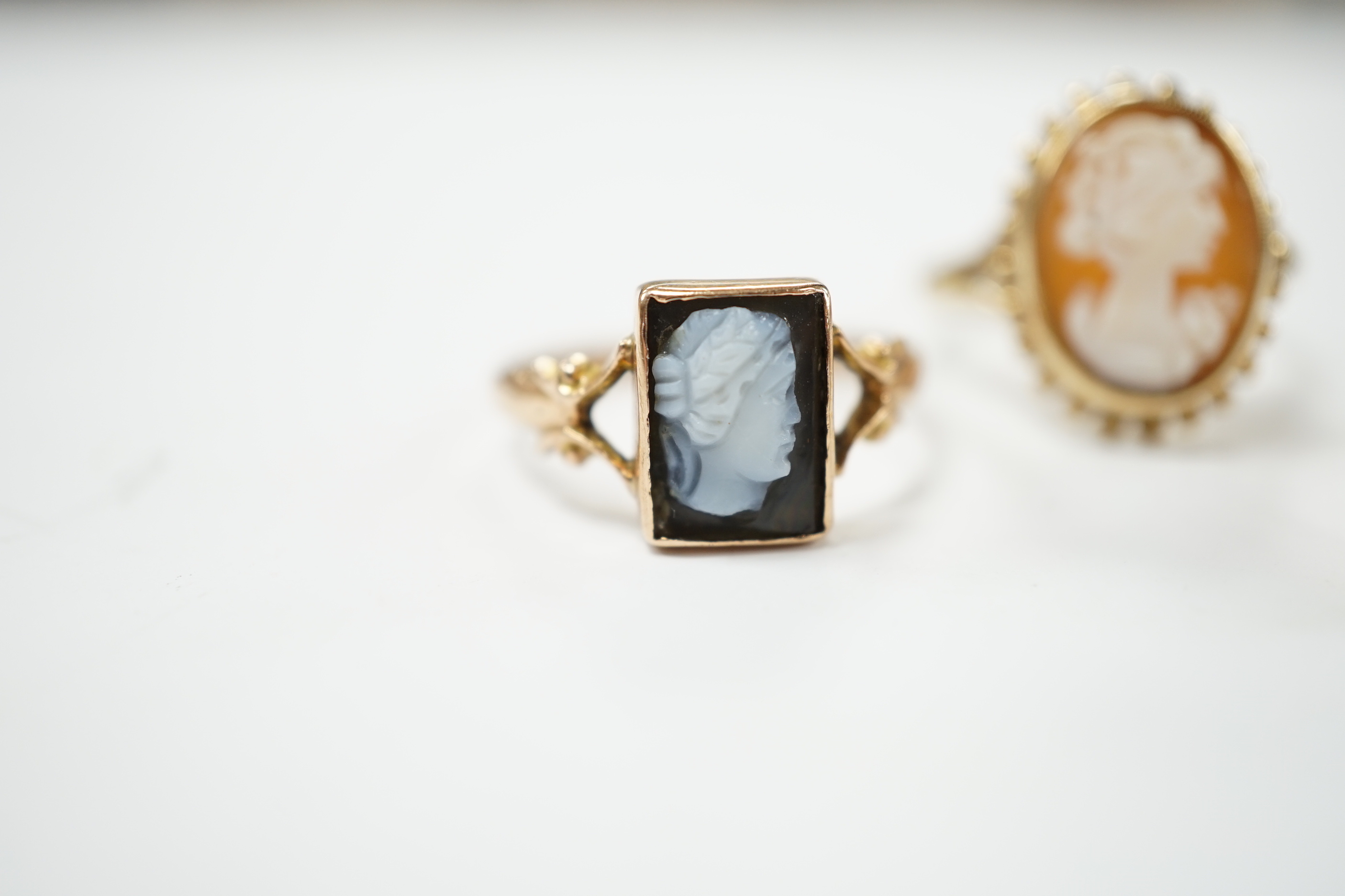 Two 9ct gold cameo rings, size N and Q, and a pearl and sapphire cluster ring, size N